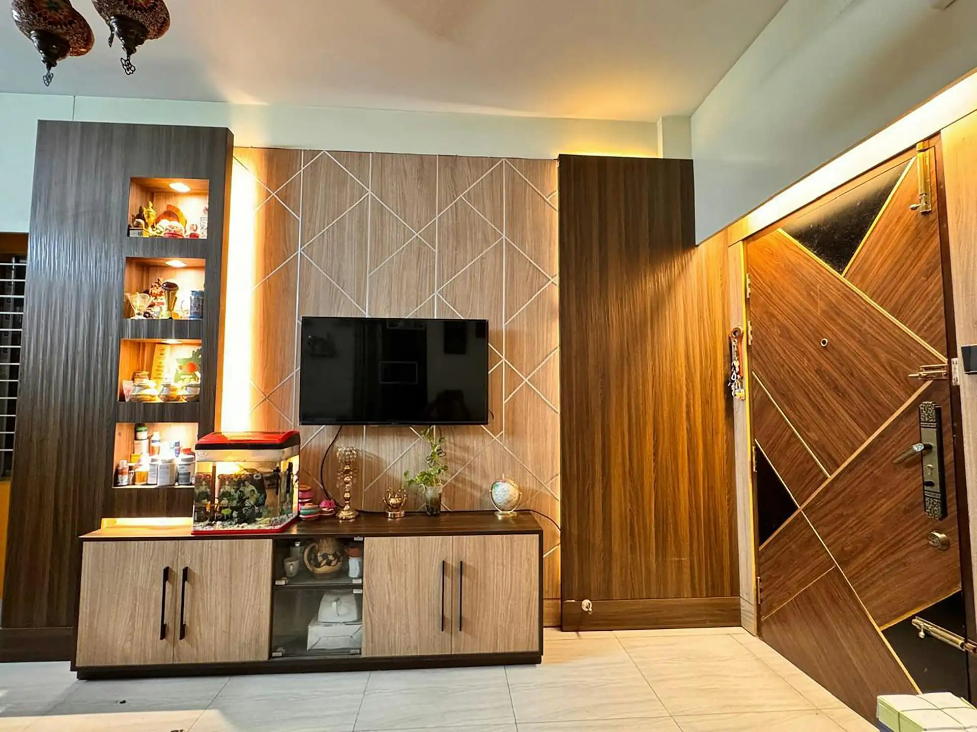 Warm condo living room with built-in TV cabinet and cove lighting
