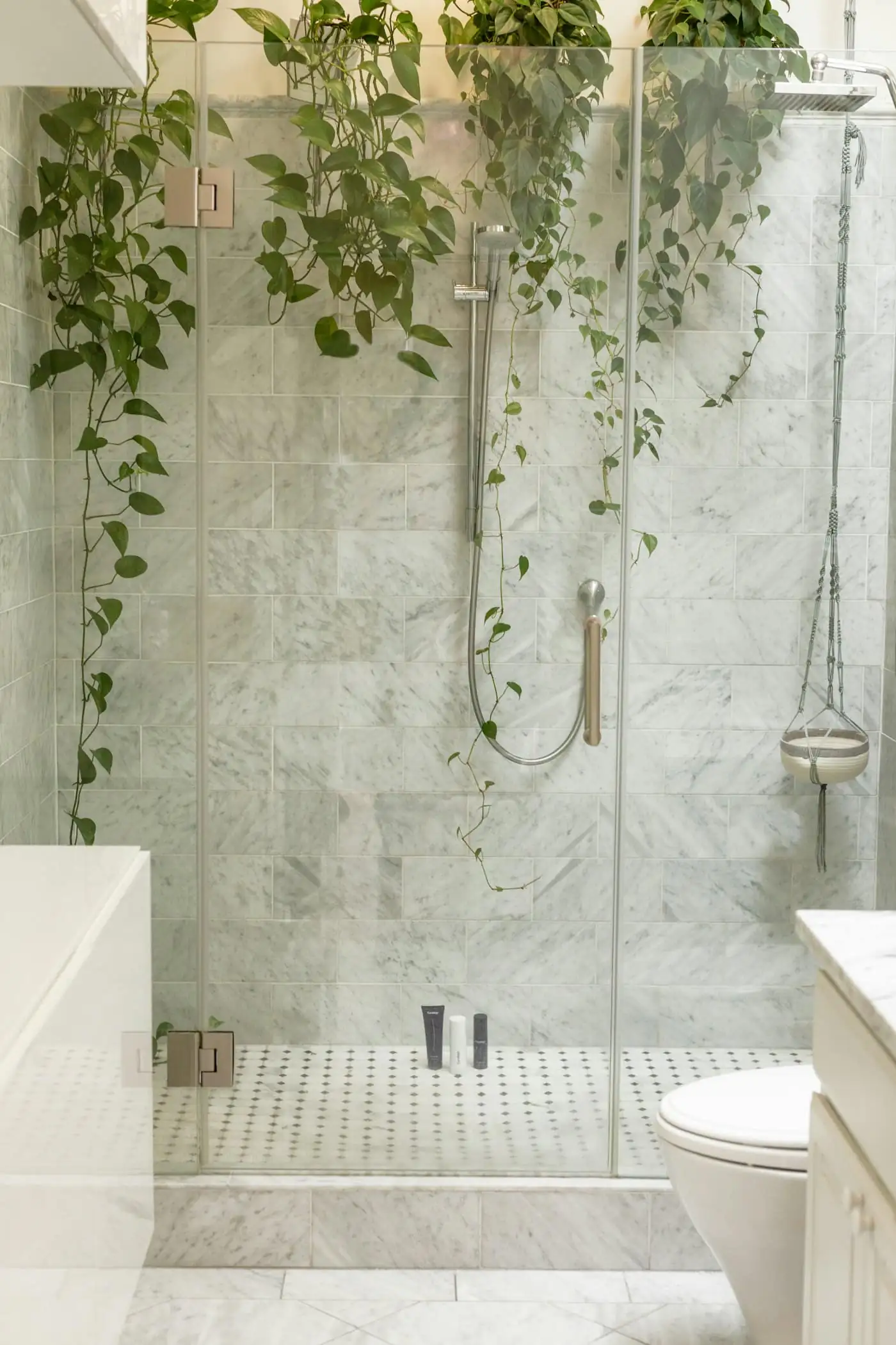 Walk-in shower with frameless glass and rain shower head